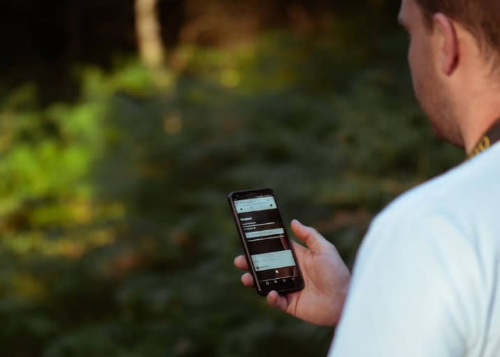 Marketing manager learning how to donate by text and testing out donation campaign on smartphone