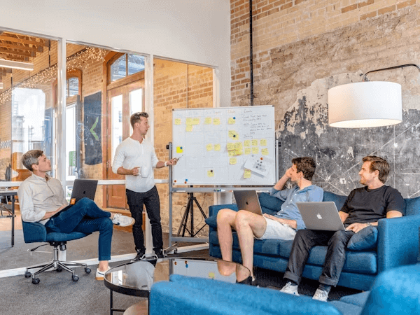 Man presenting to group at marketing agency meeting