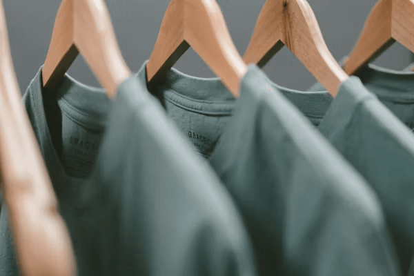Green shirts on hangers at discount store