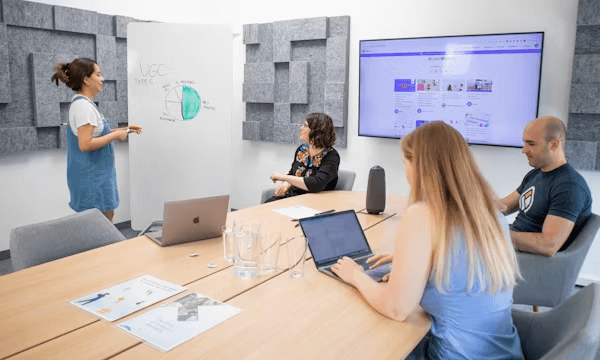 A group discussing email personalization strategies at a wooden table