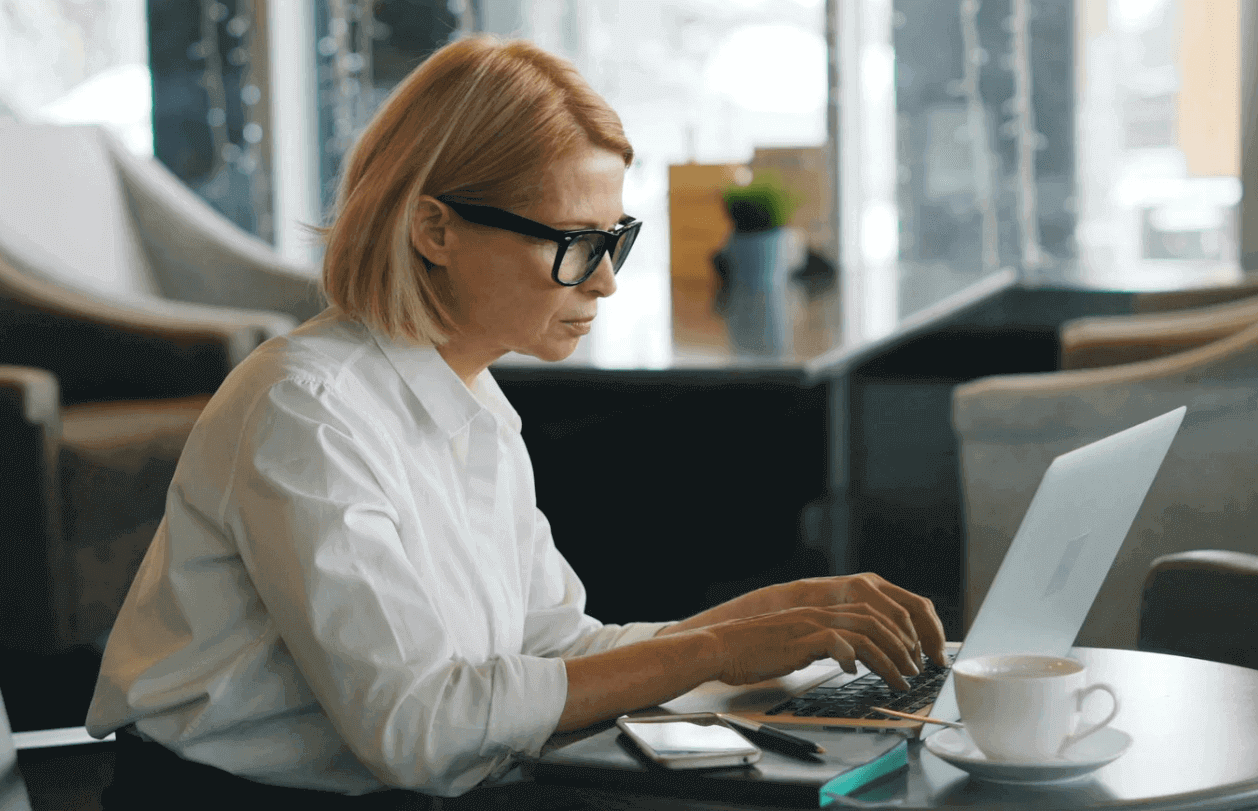 Woman using laptop for email personalization with SendGrid