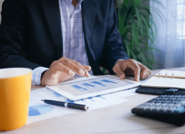 Entrepreneur analyzing business financing on a tablet with